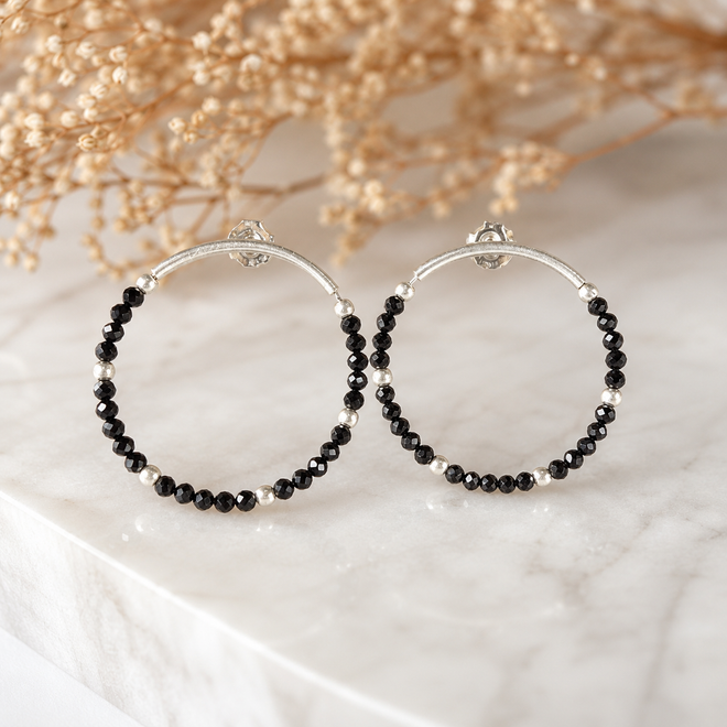 Handcrafted sterling silver hoop earrings featuring genuine faceted black spinel gemstones and matte silver accents, contemporary artisan jewelry for women.