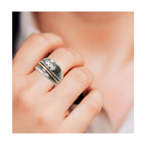 Handcrafted sterling silver ring with gold detail and bezel set cubic zirconia