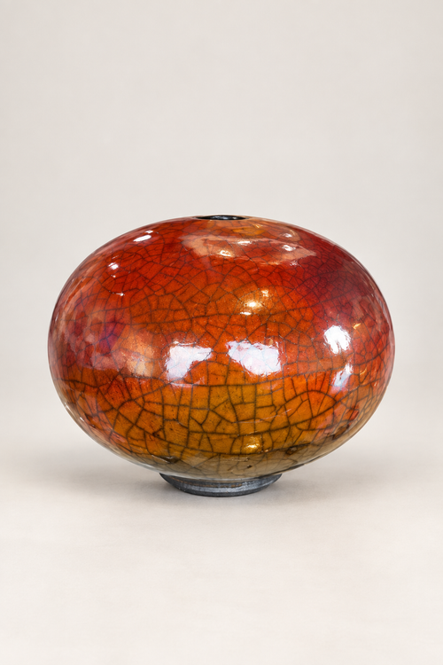 Handmade ferric chloride raku orb vase with rich orange crackle finish and small top opening