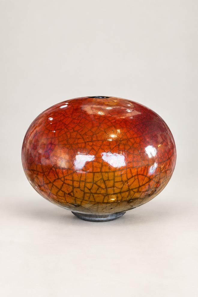 Handmade ferric chloride raku orb vase with rich orange crackle finish and small top opening