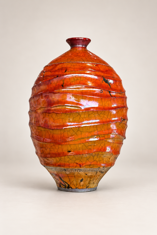 Handmade ferric chloride raku vase with rich orange crackle glaze and sculptural textured surface