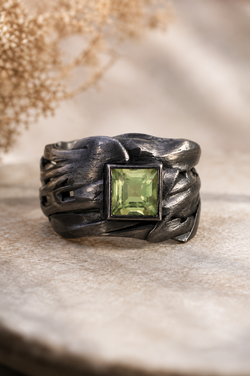 Handmade Green Amethyst ring featuring a 4mm square Green Amethyst set in oxidized sterling silver with a sculptural 0.5-inch wide artisan band. One-of-a-kind handcrafted statement ring from Raku Gallery.