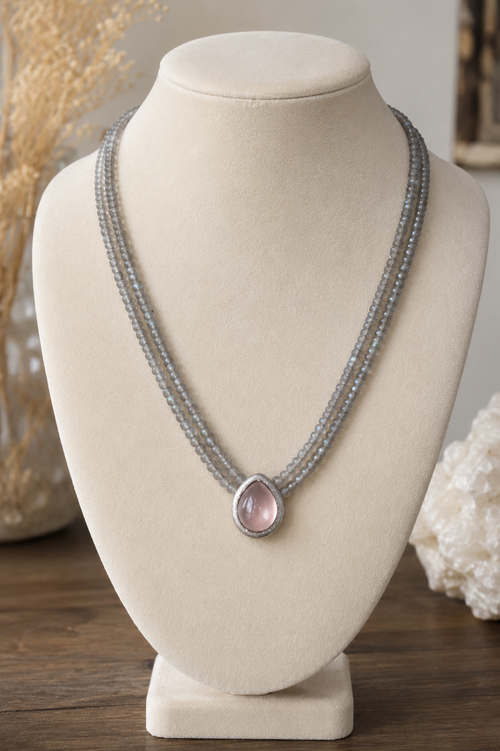 Handcrafted two strand Labradorite gemstone necklace displayed on a jewelry stand with a 9x12mm pear-shaped Rose Quartz pendant in matte dark sterling silver.