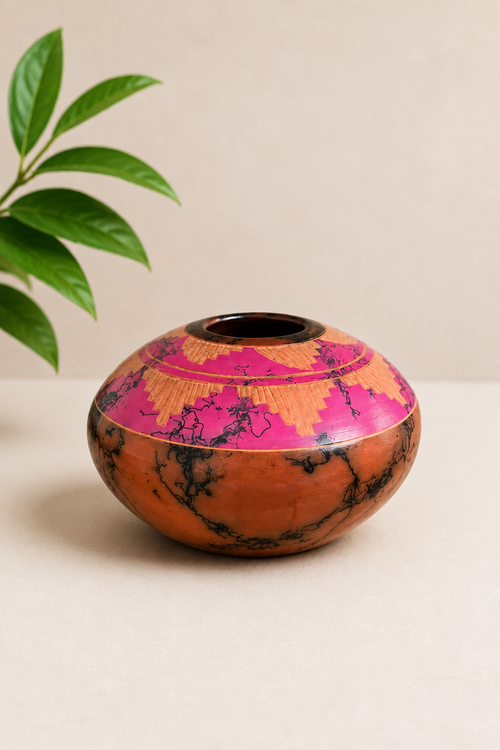 Handmade Navajo horsehair seed pot by Manuel Brieno featuring hand-carved Southwestern designs in coral pink and earth tones. Authentic Native American pottery.