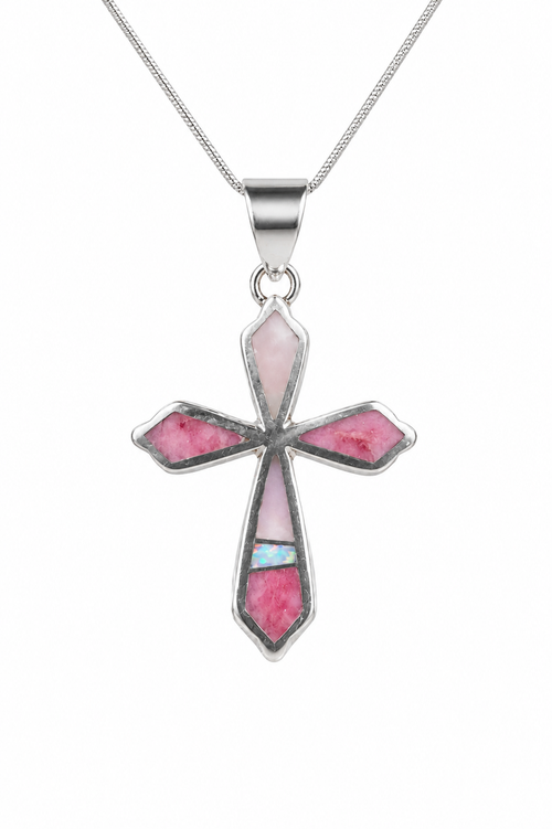 Close-up of an authentic Navajo stone inlay cross pendant featuring Pink Peruvian Opal, White Opal, and sterling silver craftsmanship.