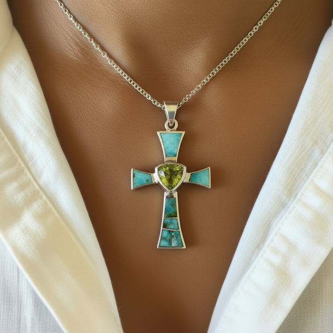 Model wearing a handcrafted Navajo sterling silver cross pendant featuring genuine Sonoran Gold Turquoise and natural Peridot. One-of-a-kind Southwestern Christian jewelry.