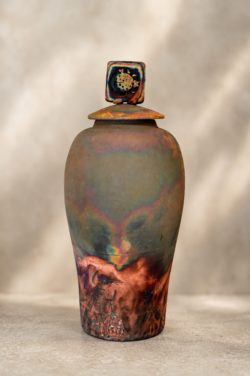 Handmade raku pottery jar with ladybug lid and copper green iridescent finish