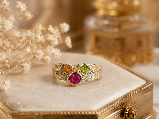 Handmade Sedona Arizona gold gemstone ring with ruby sapphire and peridot on hand