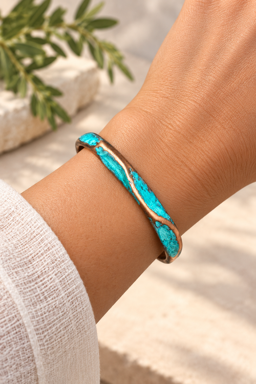 Handmade slim copper patina cuff shown on wrist with an organic turquoise-blue finish, handcrafted in Sedona, Arizona.