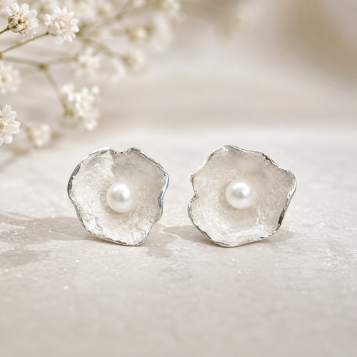 Handmade sterling silver flower stud earrings featuring genuine freshwater pearls, contemporary artisan floral jewelry with an organic sculptural design, perfect for everyday elegance and special occasions.