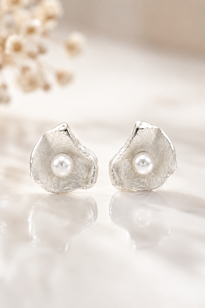 Handcrafted sterling silver petal stud earrings with genuine freshwater pearls, artisan floral jewelry featuring an organic sculptural design, perfect for weddings, gifts, and everyday elegance.