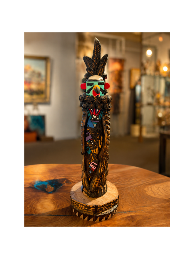 Hand-carved Eagle Kachina doll with intricate feather carvings and traditional turquoise, red, and black details