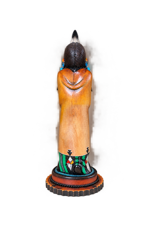 Back view of Hopi Hand Mana katsina showing carved hair, robe and colorful base details