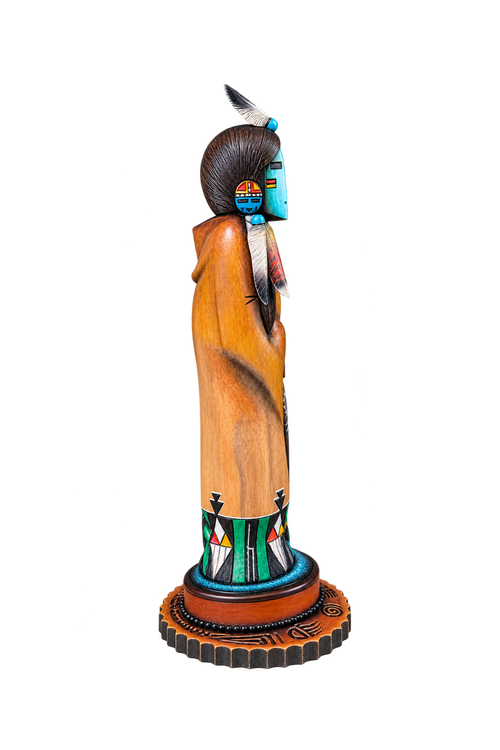 Side view of Hopi Hand Mana katsina showing detailed hand carving, feathers and painted design