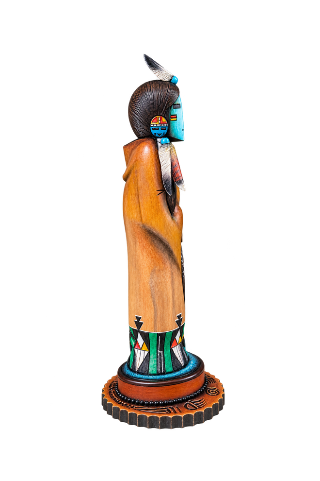 Side view of Hopi Hand Mana katsina showing detailed hand carving, feathers and painted design