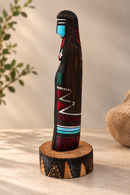 Side view of Jerold Guy Navajo Long Hair Kachina showing detailed hand-carved cottonwood and painted accents