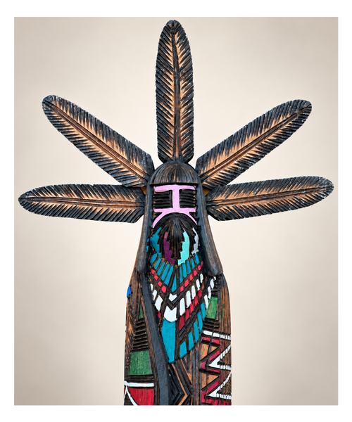 Close-up of Jerold Guy Navajo Kachina showing five carved feathers, burned-line patterns and hand-painted details