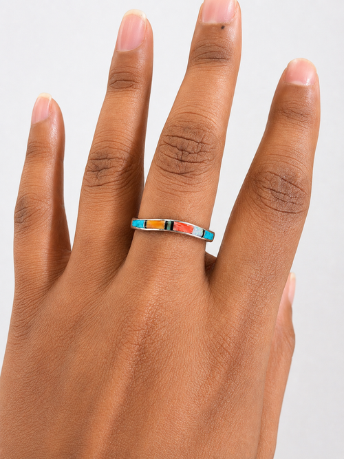 Jimmie Hoskie petite curved inlay ring with Kingman turquoise, spiny oyster, cultured white opal and black jade shown on hand