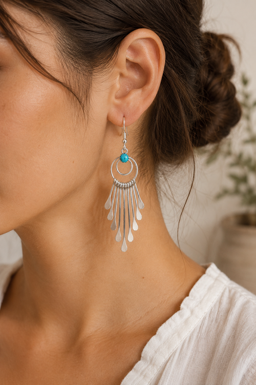 Long Navajo Kingman turquoise sterling silver dangle earrings shown on ear, 2 3/4 inches long