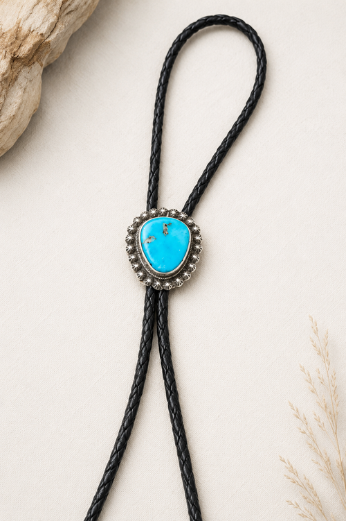 Arizona Blue Kingman turquoise bolo tie by S. Skeet with sterling silver setting and black braided leather cord