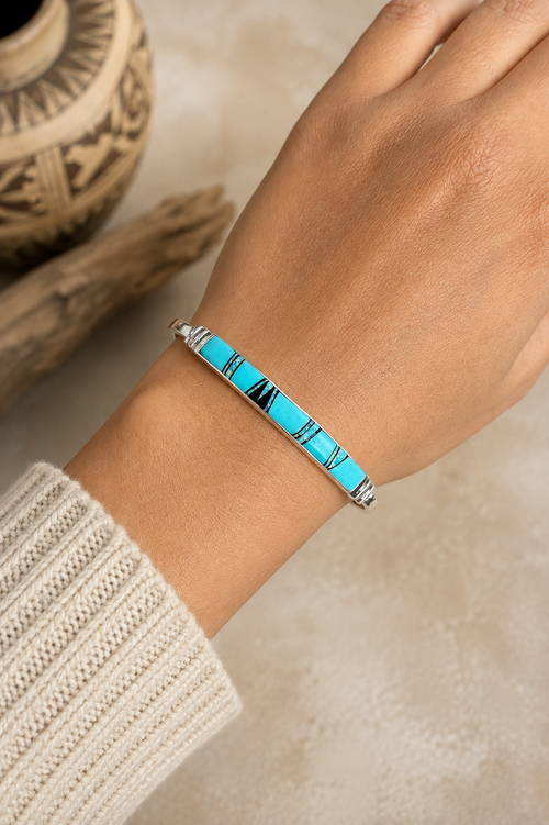 Kingman turquoise sterling silver cuff bracelet shown on wrist with opal and black jade inlay