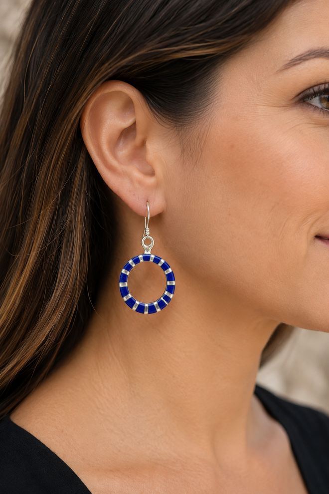 Woman wearing sterling silver lapis and mother of pearl circle earrings
