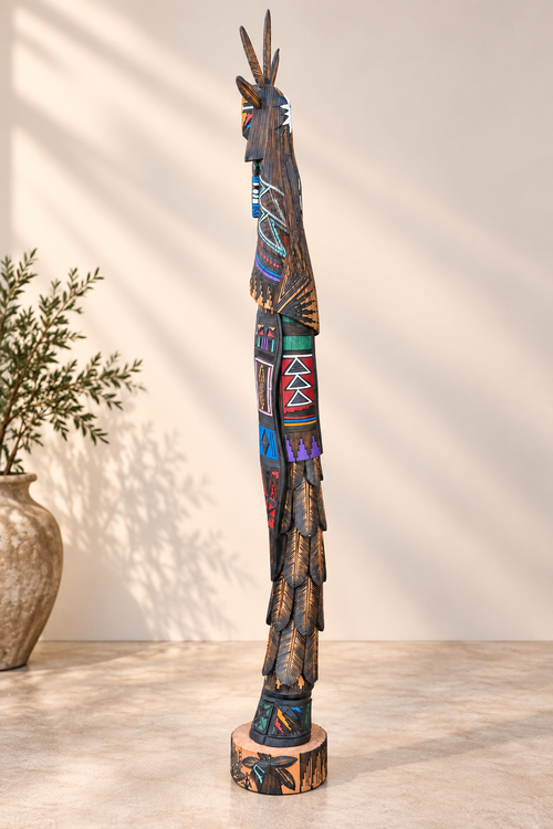 Profile view of large Navajo Kachina by Jerold Guy showing carved cottonwood, layered feather details and geometric patterns