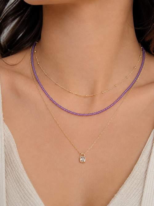 Layered amethyst necklace styled with gold chains for an elegant everyday jewelry look