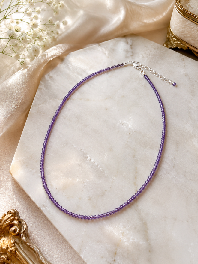 Luxury amethyst birthstone necklace displayed on marble, thoughtful February birthday gift for her
