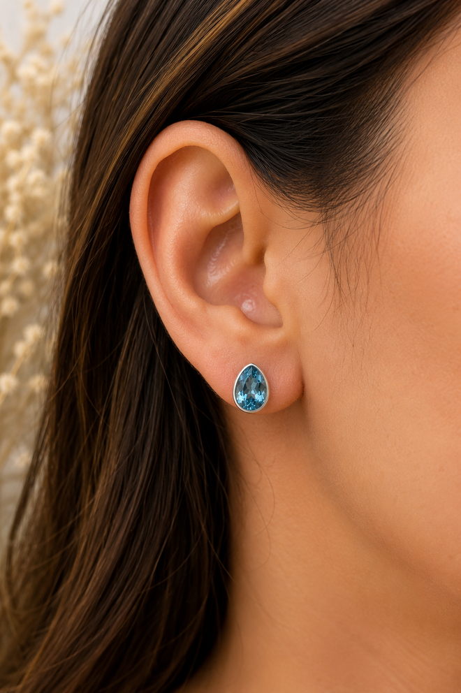 Luxury handmade Blue Topaz stud earrings crafted in sterling silver with pear-shaped natural gemstones for timeless everyday elegance.