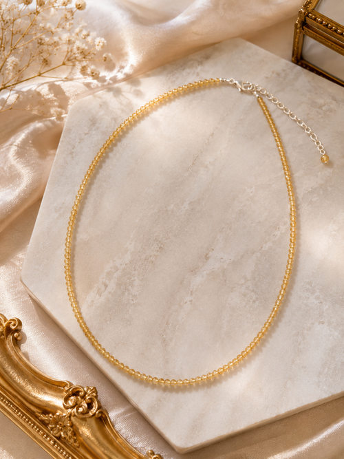 Natural citrine birthstone necklace displayed in a luxury setting as a meaningful gift for her