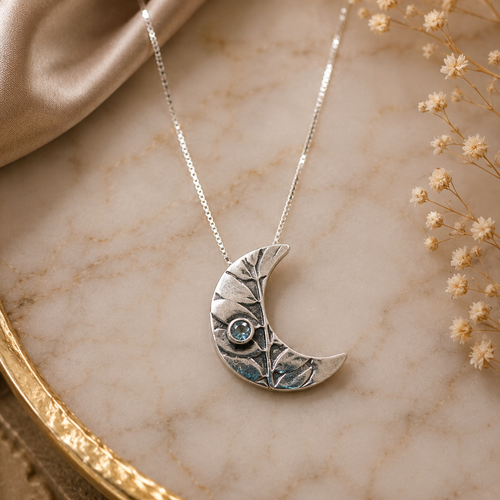 Luxury handmade crescent moon necklace with aquamarine sterling silver artisan jewelry available to shop Raku Gallery in Jerome Arizona