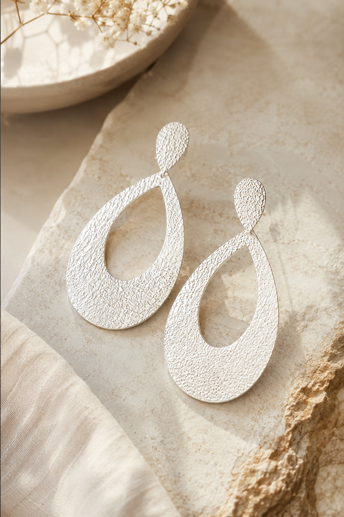 Luxury handmade sterling silver statement earrings with a hammered finish, elegant lightweight artisan jewelry for women.