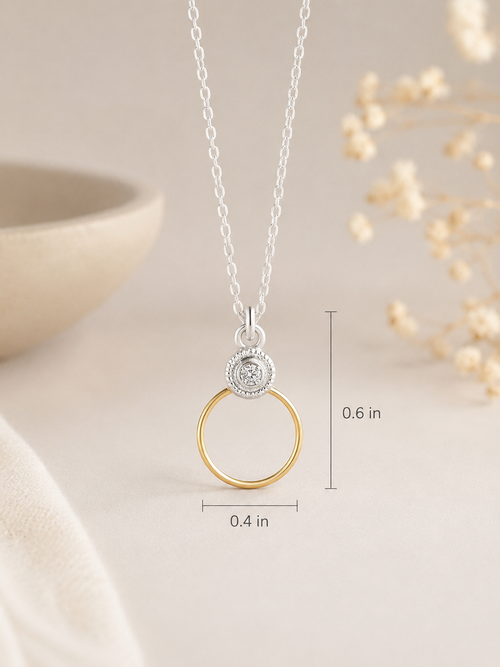 Luxury product photo of a sterling silver and gold-filled circle necklace with sparkling cubic zirconia pendant
