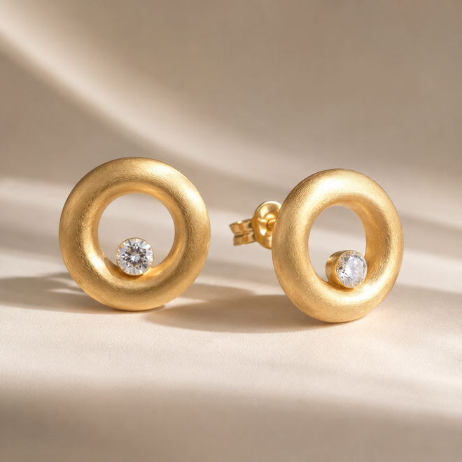 Handcrafted matte gold vermeil open circle stud earrings featuring brilliant 4 mm white cubic zirconia and a brushed satin finish in sterling silver.