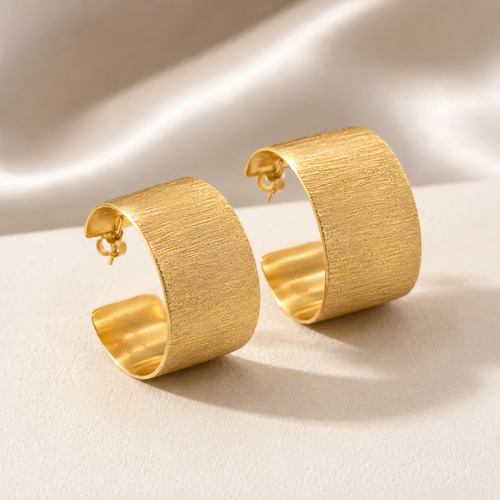 Handcrafted matte gold vermeil wide hoop stud earrings in sterling silver with a brushed satin finish, modern contemporary statement jewelry for women.