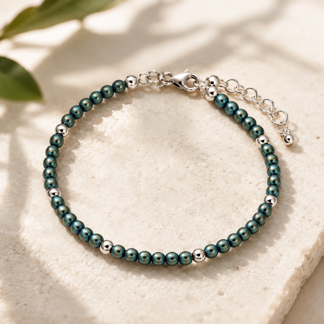 Handcrafted matte green-blue hematite bracelet featuring 3 mm hematite beads, polished sterling silver accent beads, and an adjustable sterling silver extension chain.