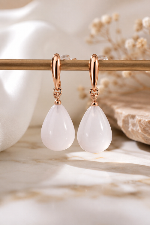 Handmade milky quartz pear drop earrings in rose gold plated sterling silver featuring luminous white gemstones and a timeless minimalist design.