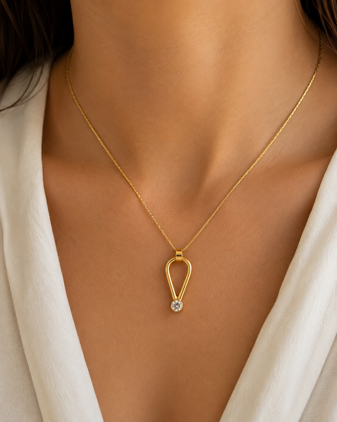 Minimalist gold necklace with contemporary open-form pendant and sparkling cubic zirconia