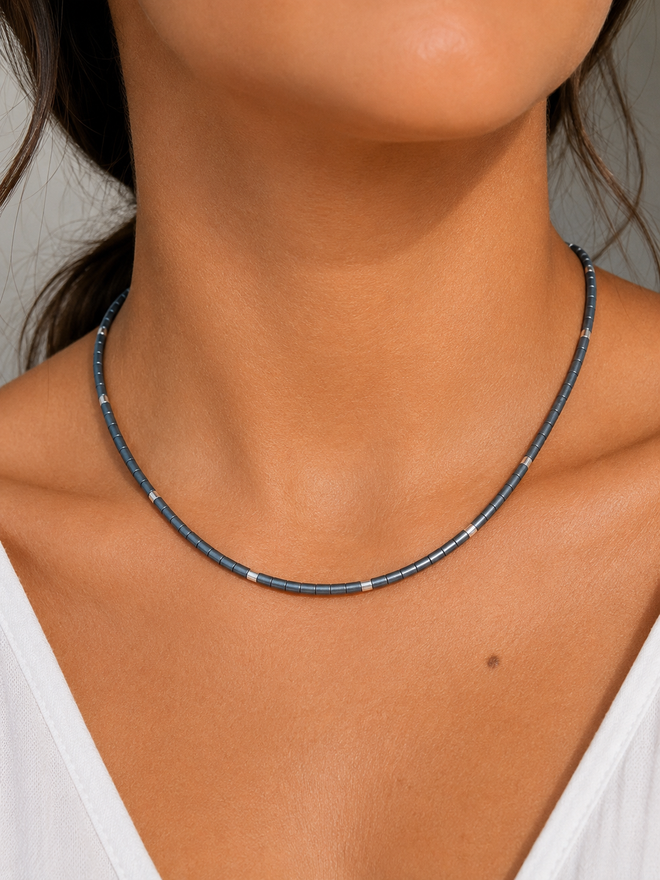 Grey hematite necklace with sterling silver accents worn on a model, showcasing a modern minimalist fit.