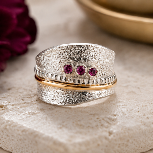 Mixed metal rhodolite garnet ring with sterling silver texture and 14K gold detail