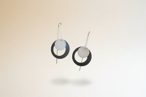 Modern geometric sterling silver earrings with overlapping circular design and long ear wires