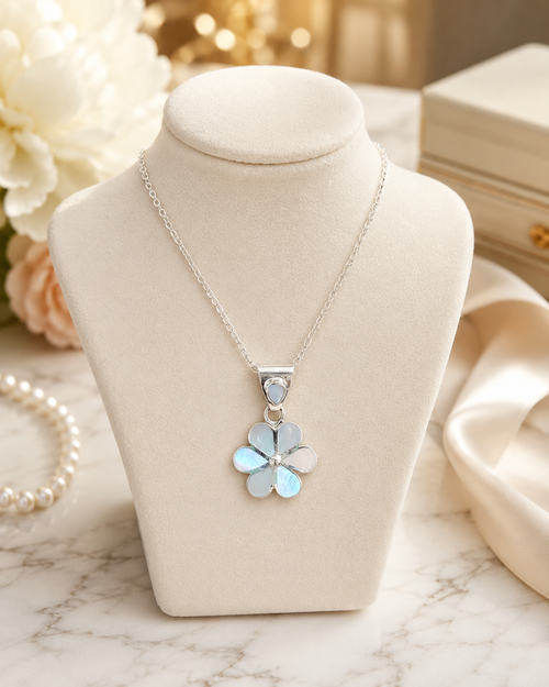 Mother of pearl flower pendant necklace displayed in a luxury jewelry setting with elegant styling