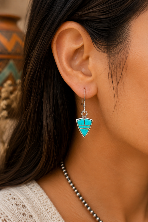 Native American Kingman turquoise inlay sterling silver earrings by Priscilla Lewis shown on ear