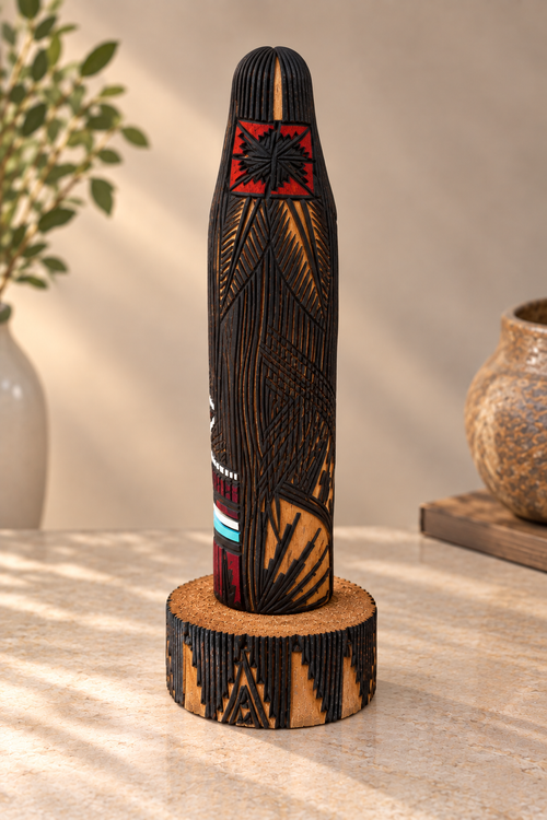 Back view of Jerold Guy Long Hair Kachina showing intricate burned-line patterns carved into cottonwood