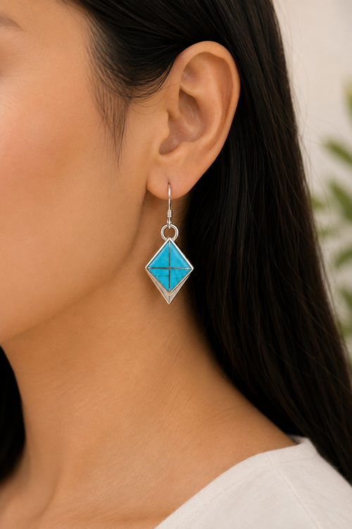 Navajo Kingman Turquoise sterling silver earrings worn on ear showing their petite dangle size