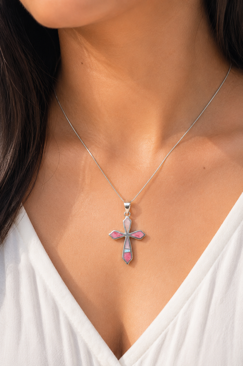 Handmade Navajo Pink Peruvian Opal and White Opal sterling silver cross necklace worn on a model, authentic Native American handcrafted jewelry.