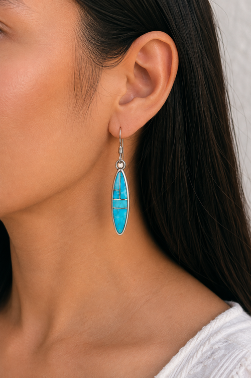 Navajo Kingman Turquoise dangle earrings worn on ear showing the slim 1.5 inch size