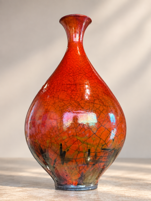 One-of-a-kind ferric chloride Raku vessel by Bob Smith with red-orange tones, dark crackle lines and fire-and-smoke surface markings