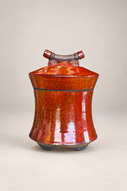 One-of-a-kind handmade raku pottery vessel shown with sculptural lid open